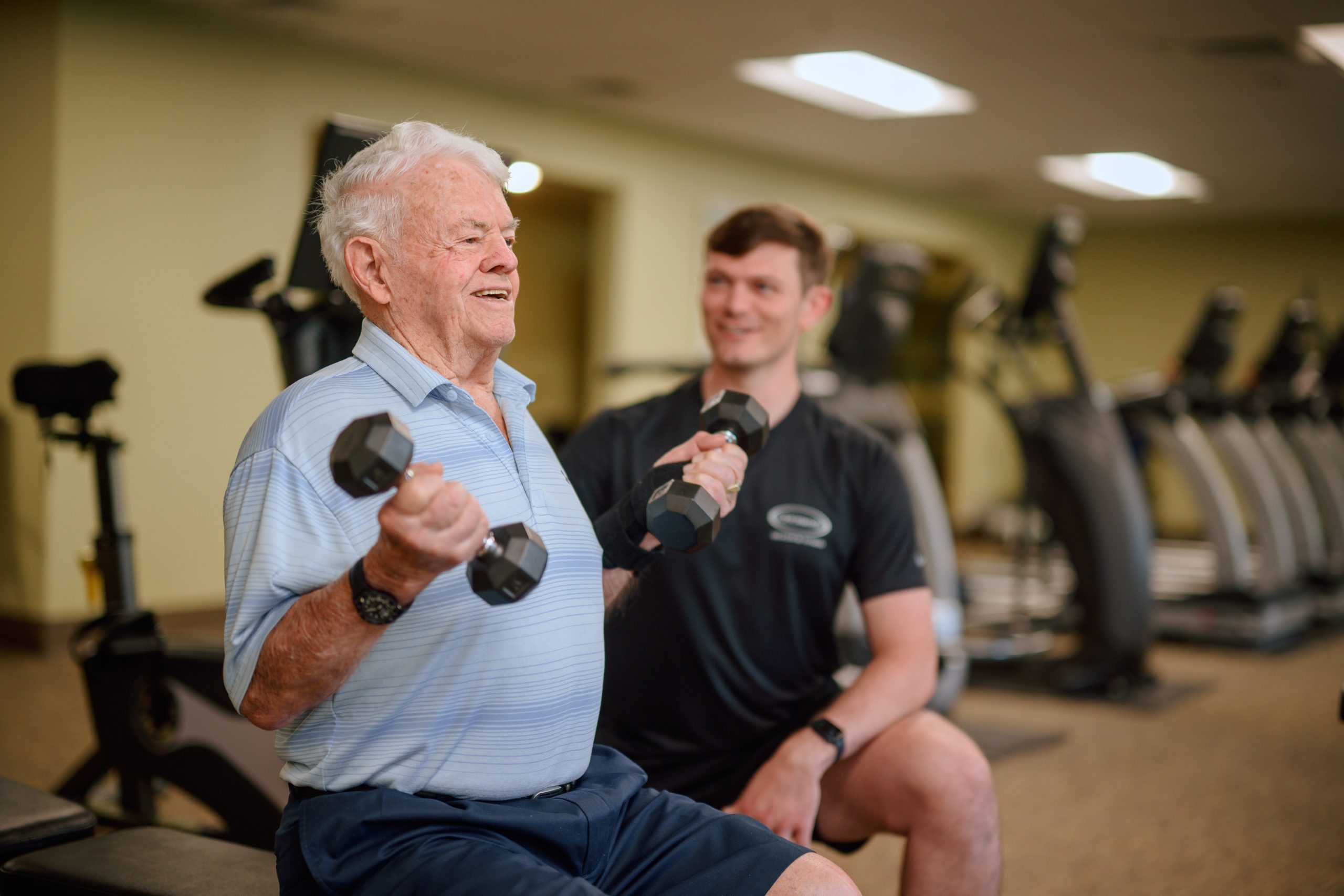 TM-Lifestyle-4-1253-web Resident lifting weights under supervision of team member